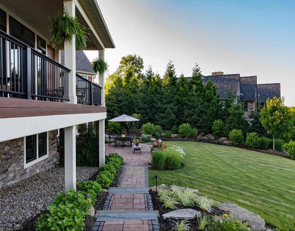 Cozy stone fire pit with lakeside views in a luxury outdoor living space in Novelty, OH-1
